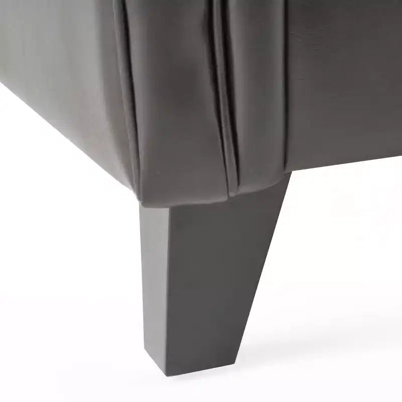 Fauteuil club capitonné en cuir reconstitué contemporain avec accoudoirs roulés