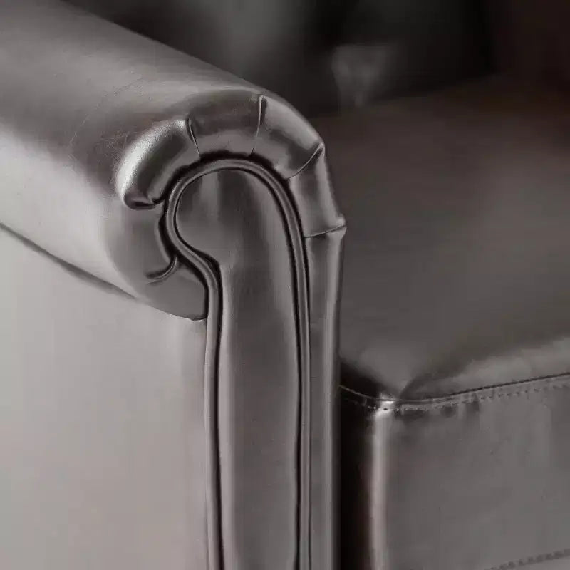 Fauteuil club capitonné en cuir reconstitué contemporain avec accoudoirs roulés